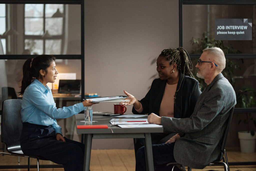 Young businesswoman negotiating job offer during a meeting with recruitment team.