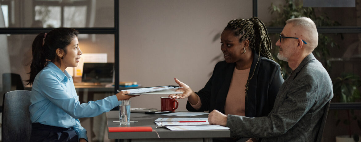 Young businesswoman negotiating job offer during a meeting with recruitment team.