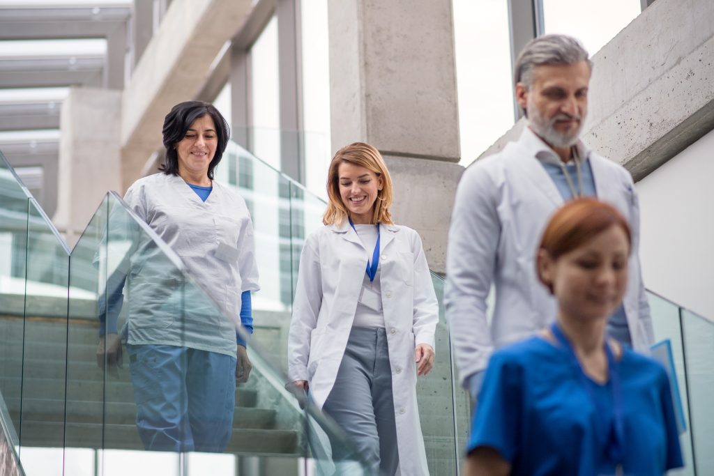 Group of doctors walking down stairs on medical conference.