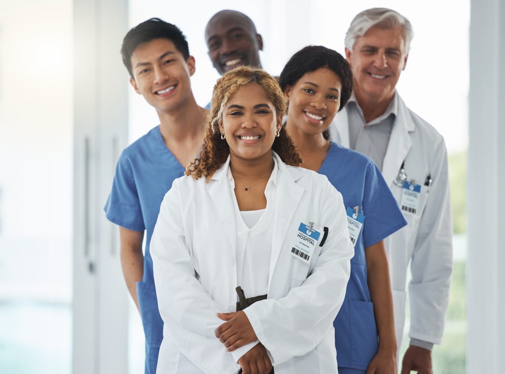 Portrait of a group of medical practitioners standing together in a hospital.