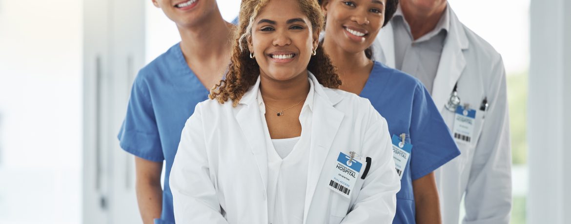 Portrait of a group of medical practitioners standing together in a hospital.